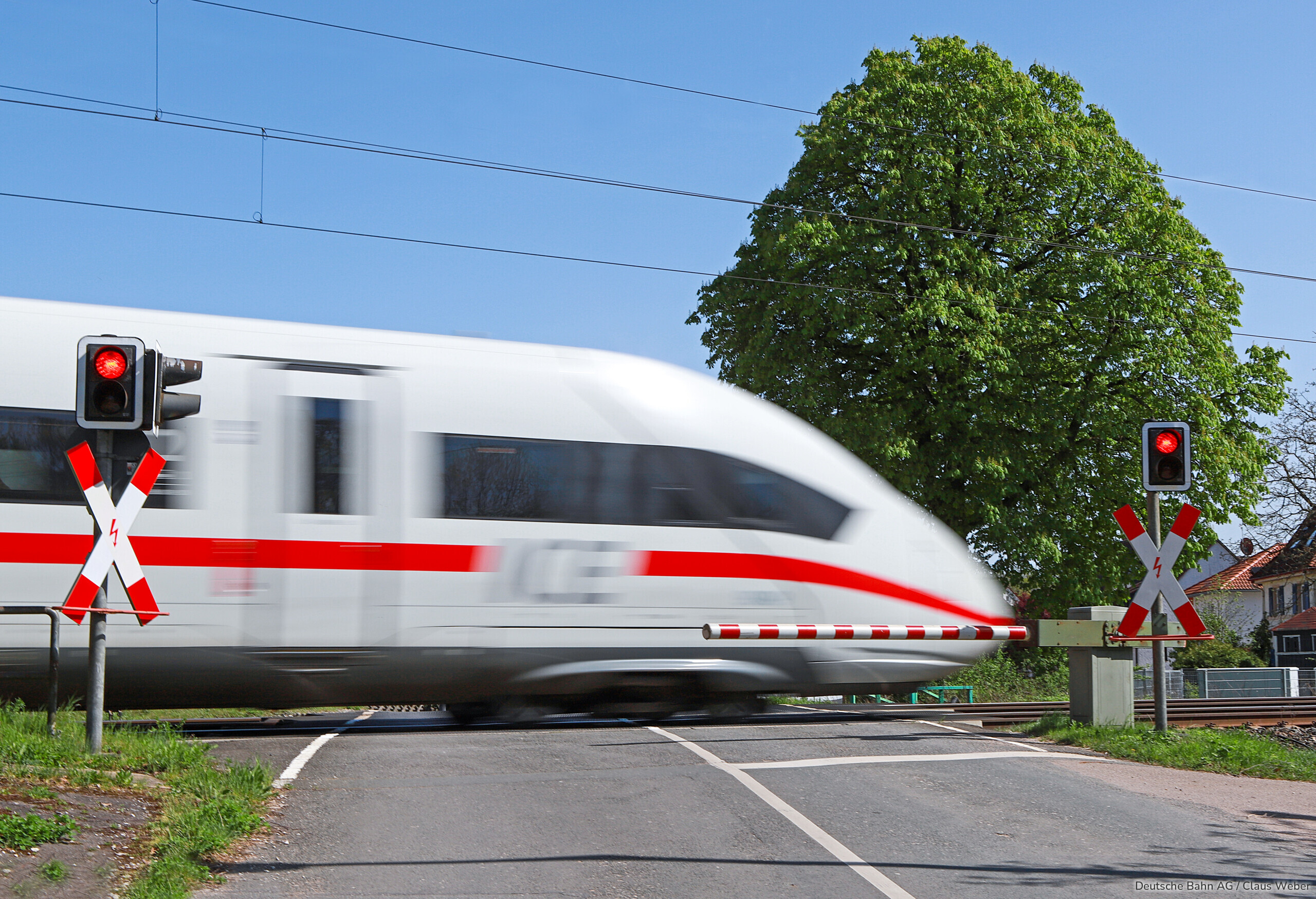 ICE fährt über Bahnübergang.