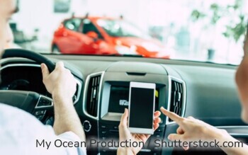 Junges Ehepaar nutzt die i-Kfz-App für Ihren digitalen Fahrzeugschein.